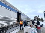 A lot of luggage getting unloaded from the baggage car 